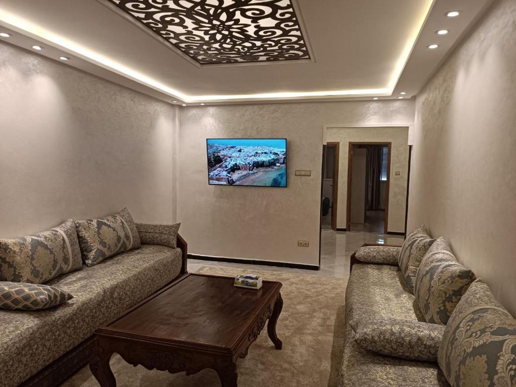 a living room with a couch and a coffee table at Aprt Hassan rba in Rabat