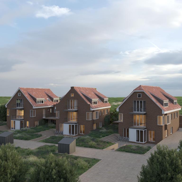 a rendering of three homes with red roofs at Schwalbennest 1-3 in Juist