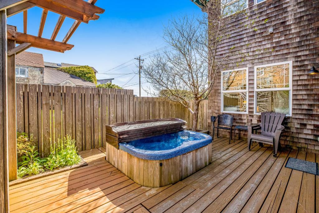 a hot tub on a wooden deck with a table at Bennington House in Newport