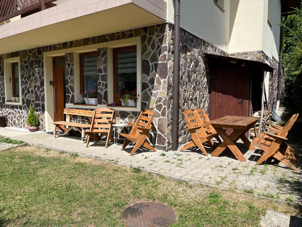 a group of chairs and a table outside of a house at Apartmán Laza in Donovaly