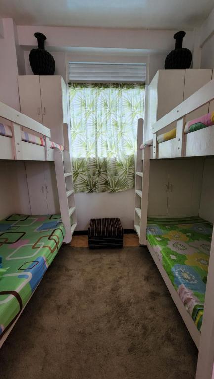 Postel nebo postele na pokoji v ubytování Havilah House Baguio City