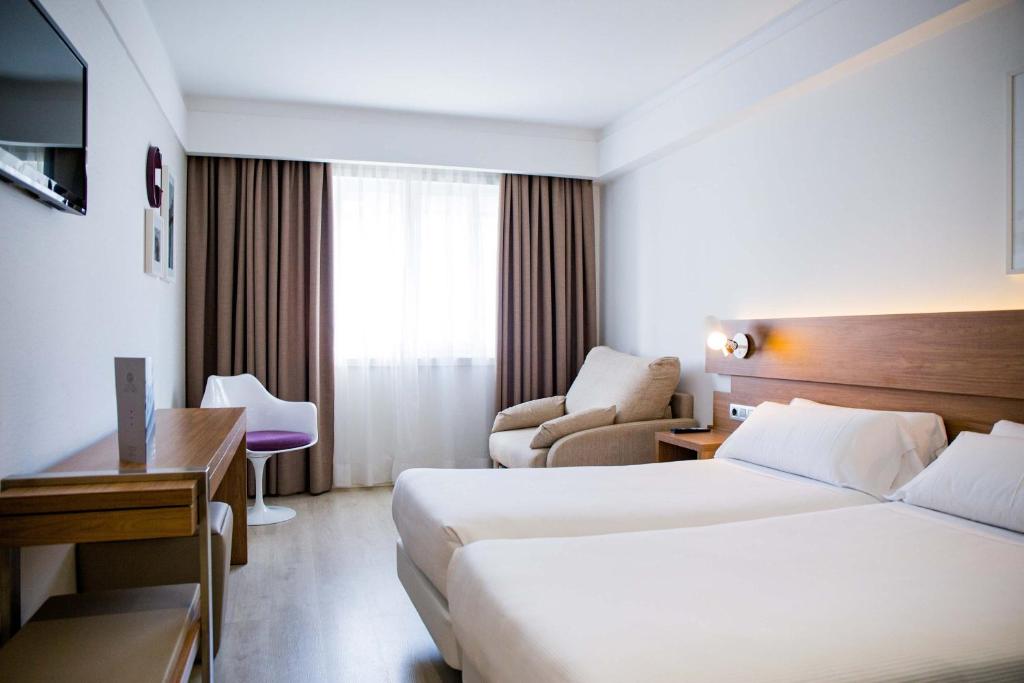Säng eller sängar i ett rum på Hotel Gelmírez