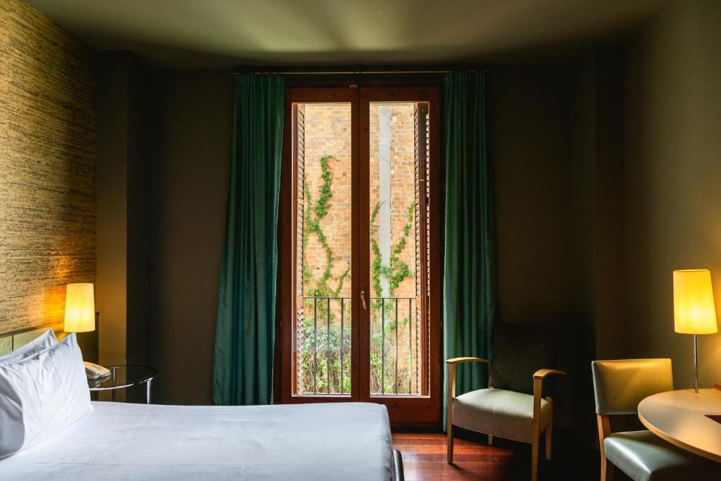 Posteľ alebo postele v izbe v ubytovaní Fonda Hotel 1771