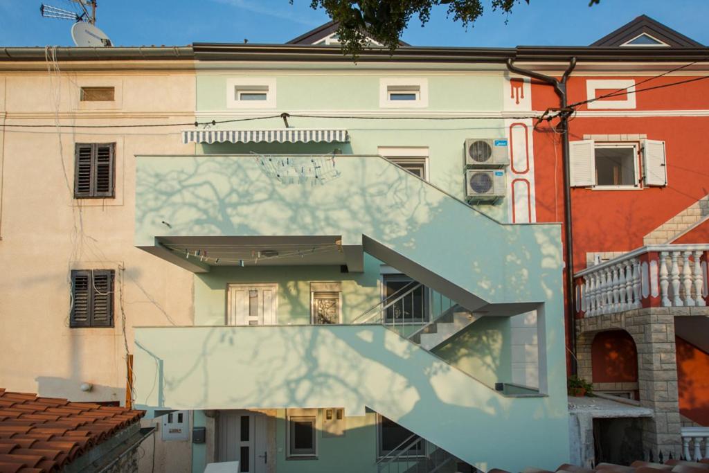 a building with a staircase in front of it at Apartment MiMa in Medulin