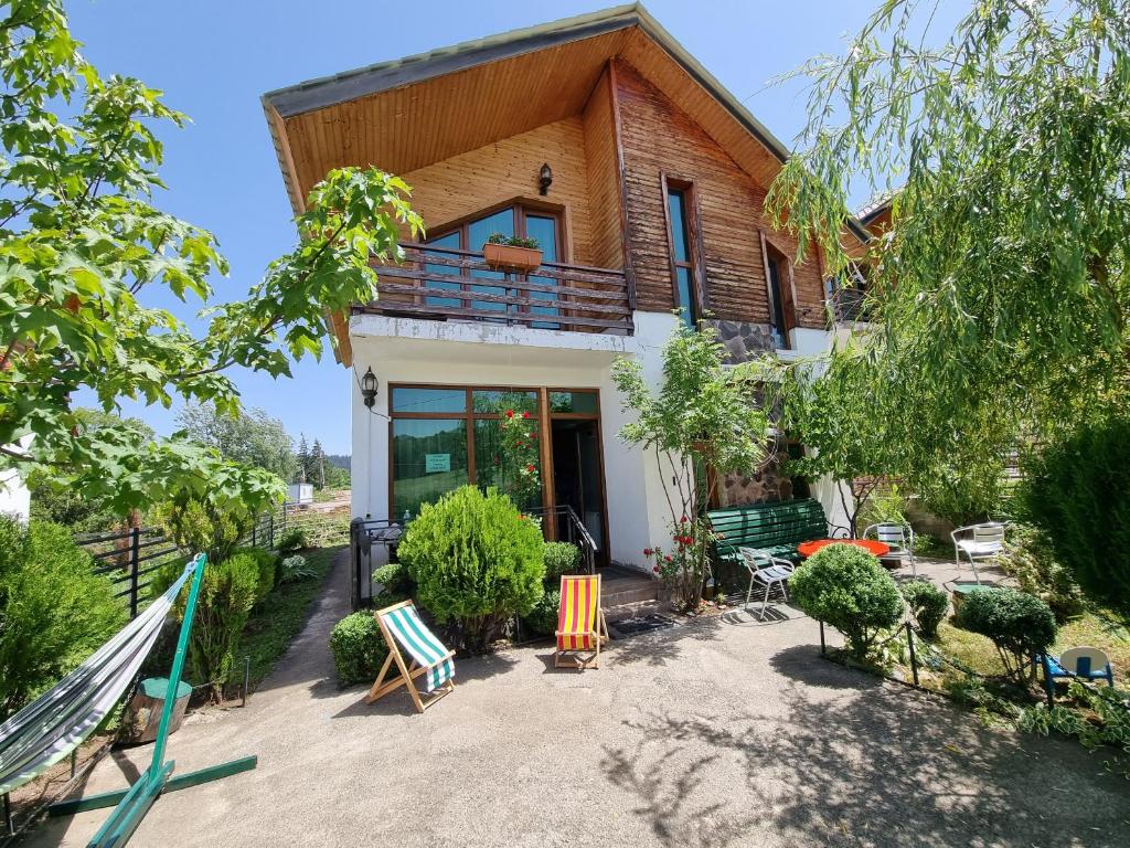 a house with a balcony and a patio at Villa Sun Valley in Bakuriani