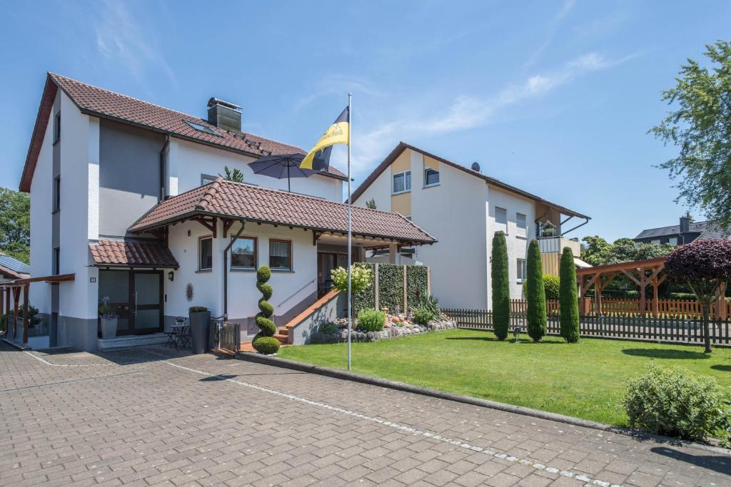 a house with a flag in the yard at Haus Schussenblick Og in Eriskirch