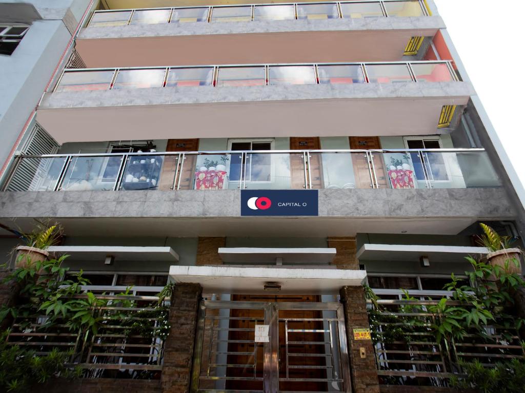 a building with a sign on the front of it at Capital O 806 Pattaui Residences in Manila