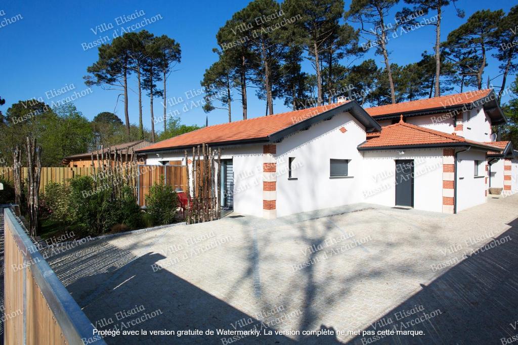 une maison blanche avec un toit rouge dans l'établissement Gite Villa Elisaia location de meublés de tourisme chez l'habitant, à Arès