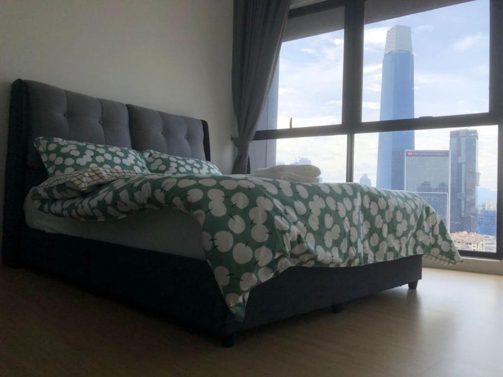 a bed in a room with a large window at Lovely Continew Residence 2 Bedrooms - KL in Kuala Lumpur