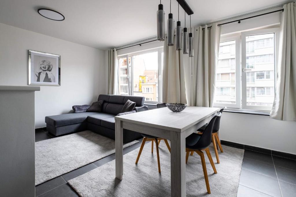 uma sala de estar com uma mesa e um sofá em Appartement Ann em Blankenberge