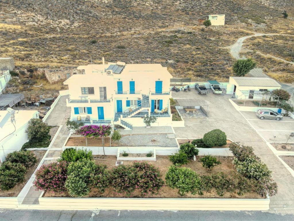 an aerial view of a house with a parking lot at Zeus Apartments in Xerokampos