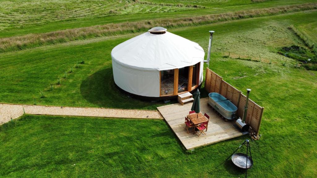 an aerial view of a yurt in a field at Embrace the Space in Cwm-Morgan