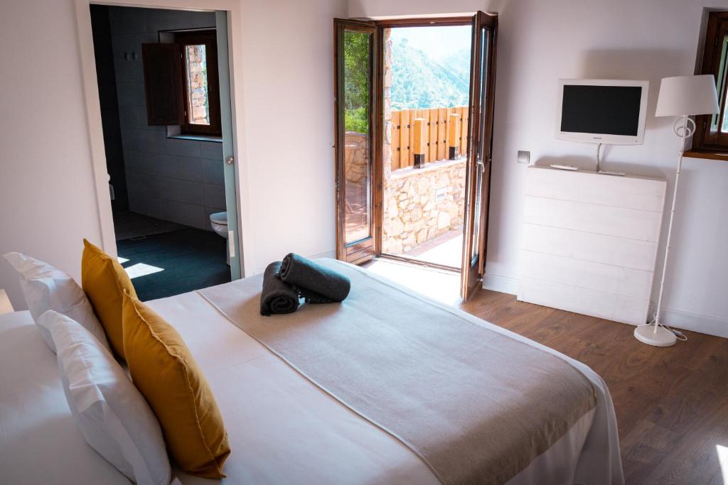 Postel nebo postele na pokoji v ubytování Hotel Mas Mariassa