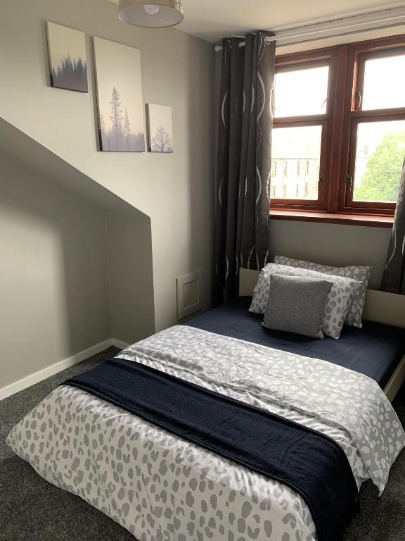 a bedroom with a large bed with a window at South Street in Balfron