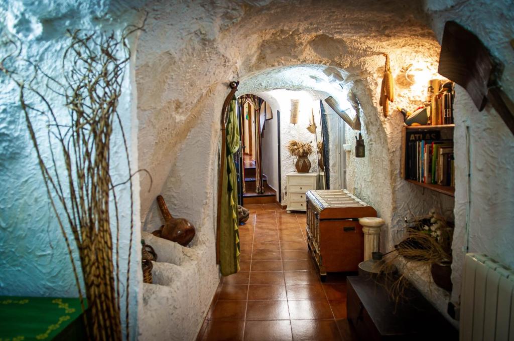 a hallway in a house with a stone wall at Casa Cueva Alegría in Valdeganga