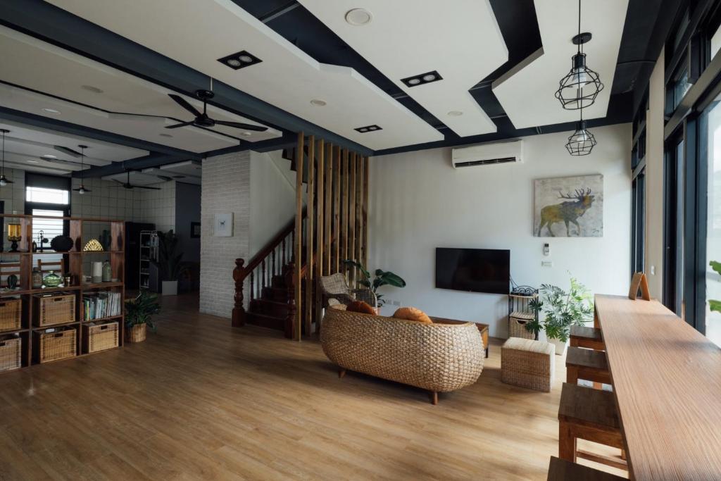 a living room with a couch and a tv at 5963 Turn Right B&B in Jiaoxi