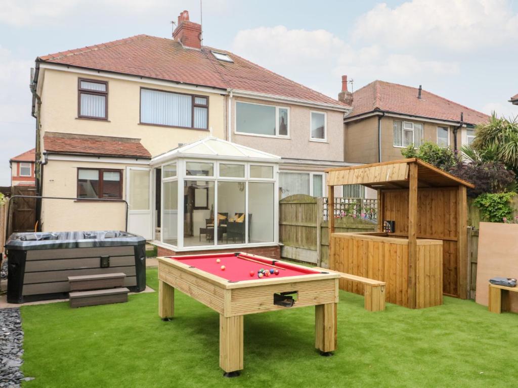 a backyard with a pool table and a house at 71 Nutter Road in Cleveleys