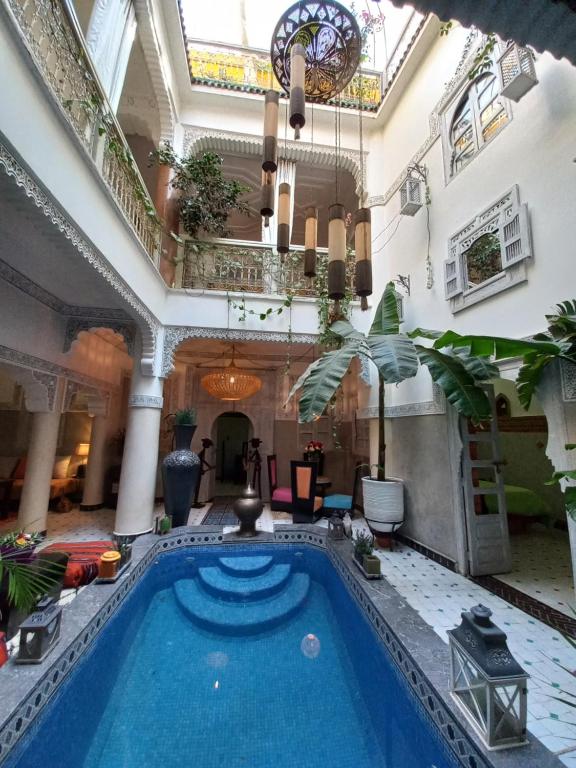 an indoor pool in the lobby of a building at Riad Eloise in Marrakech