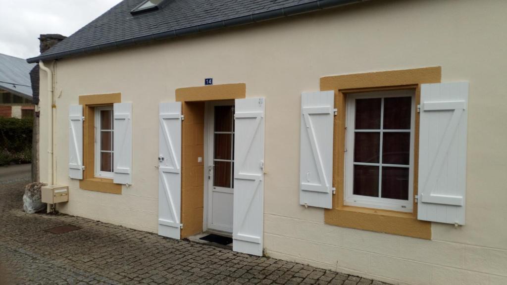 szereg drzwi i okien na budynku w obiekcie petite maison chaleureuse w mieście Irvillac