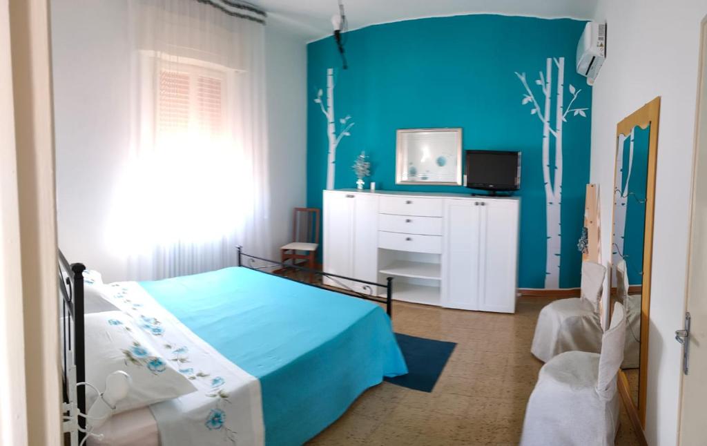 una camera con letto e parete blu di B&B Il Giardino di Sophie a Villafranca di Forlì