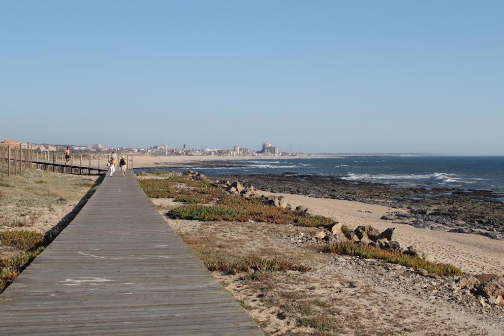 a boardwalk leading to a beach with animals on it at Hotel Monte Lírio in Espinho