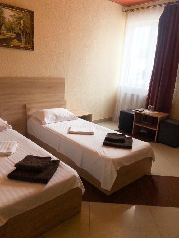 Postel nebo postele na pokoji v ubytování Kontinent Hotel
