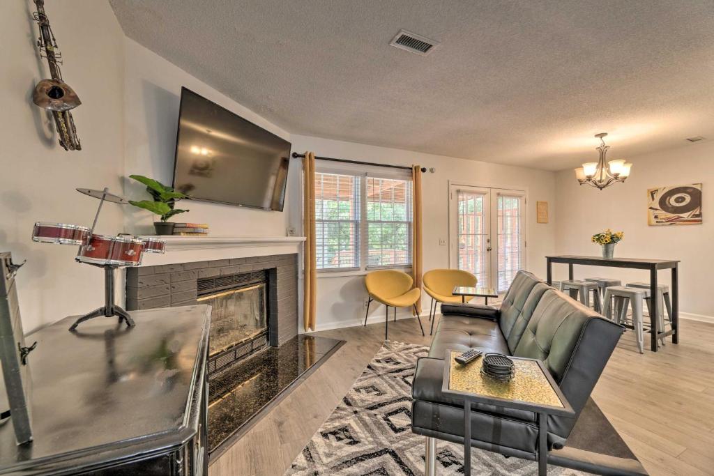 a living room with a couch and a fireplace at Modern Nashville Townhome Large Yard and Deck! in Nashville