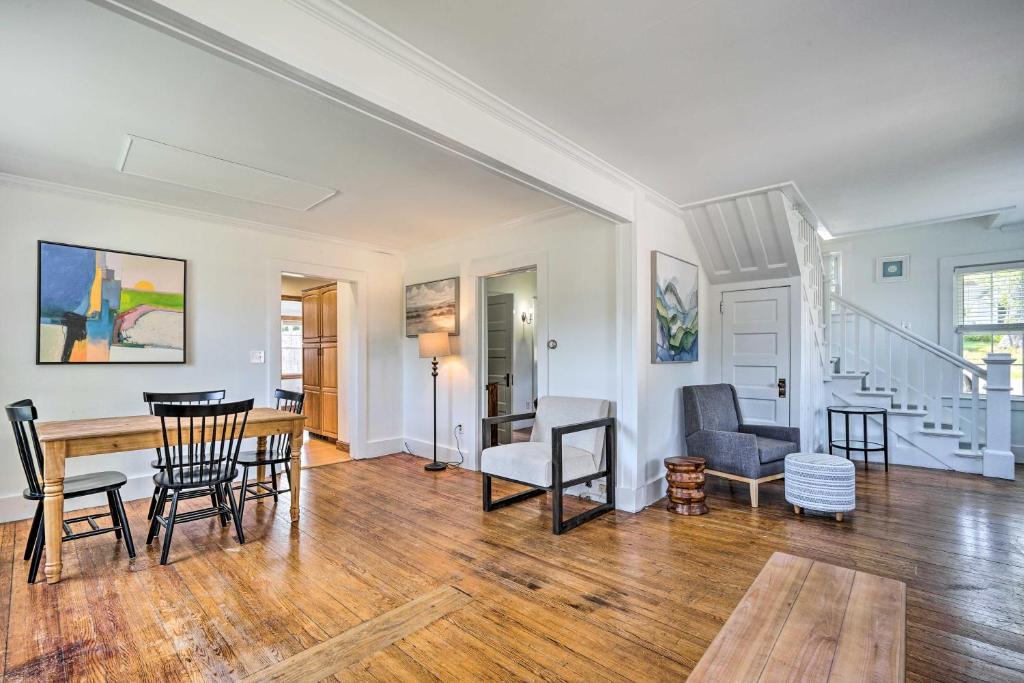 an empty living room with a table and chairs at Cheery Family Escape with Game Room and Fire Pit! in Lake George