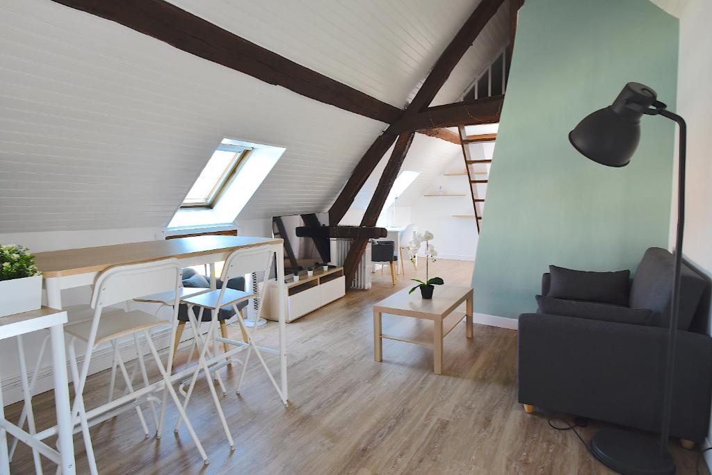 a living room with a table and a couch at Welcome Home in Linas
