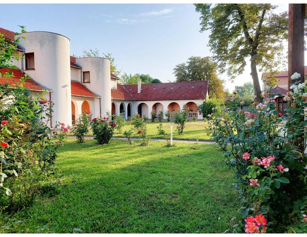 a large house with a yard with flowers at Gosztonyi Villa in Siófok