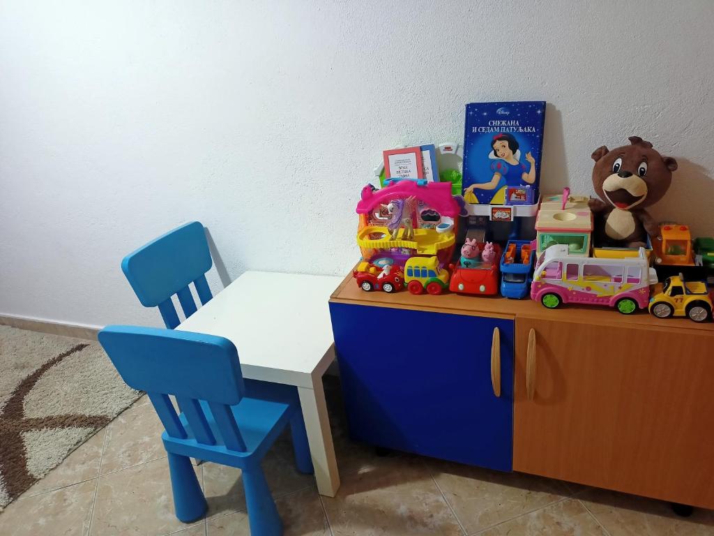 a childs table with toys on top of it at Anika in Sutomore