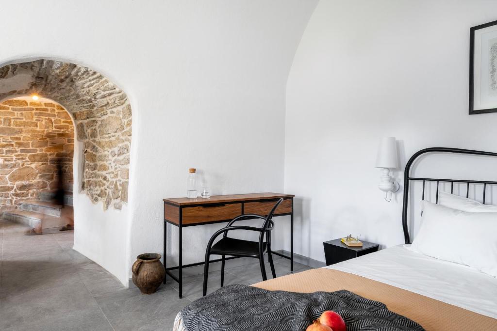 a bedroom with a bed and a table and a desk at Bridges Residence in Veliko Tŭrnovo