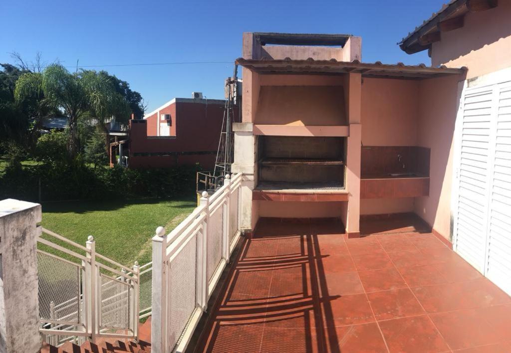 a balcony of a house with a white fence at Complejo Familiar EL VIEJO MOLINO in Paso de la Patria