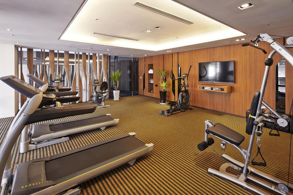 a fitness room with treadmills and cardio machines at La Vida Hotel in Taichung