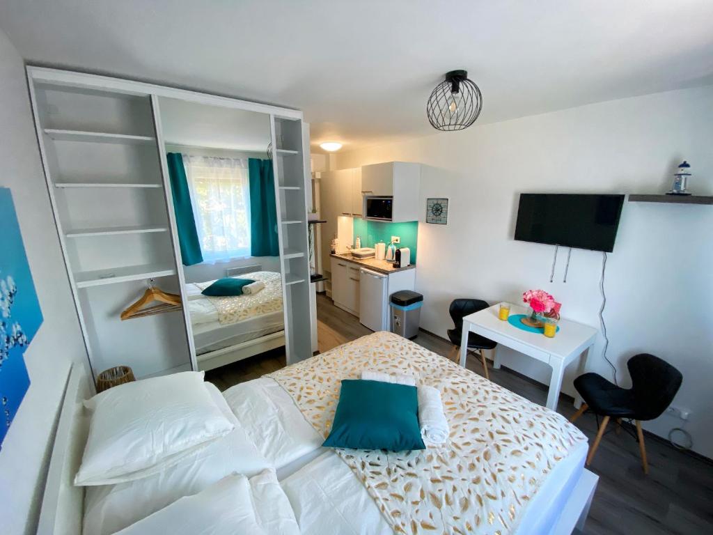 Schlafzimmer mit einem Bett, einem Schreibtisch und einem Spiegel in der Unterkunft Málna Apartman Juventus in Balatonföldvár