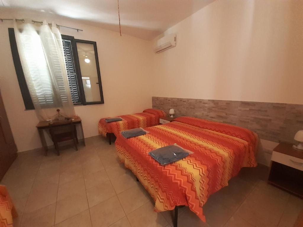 Postel nebo postele na pokoji v ubytování L'Ulivo di Lu