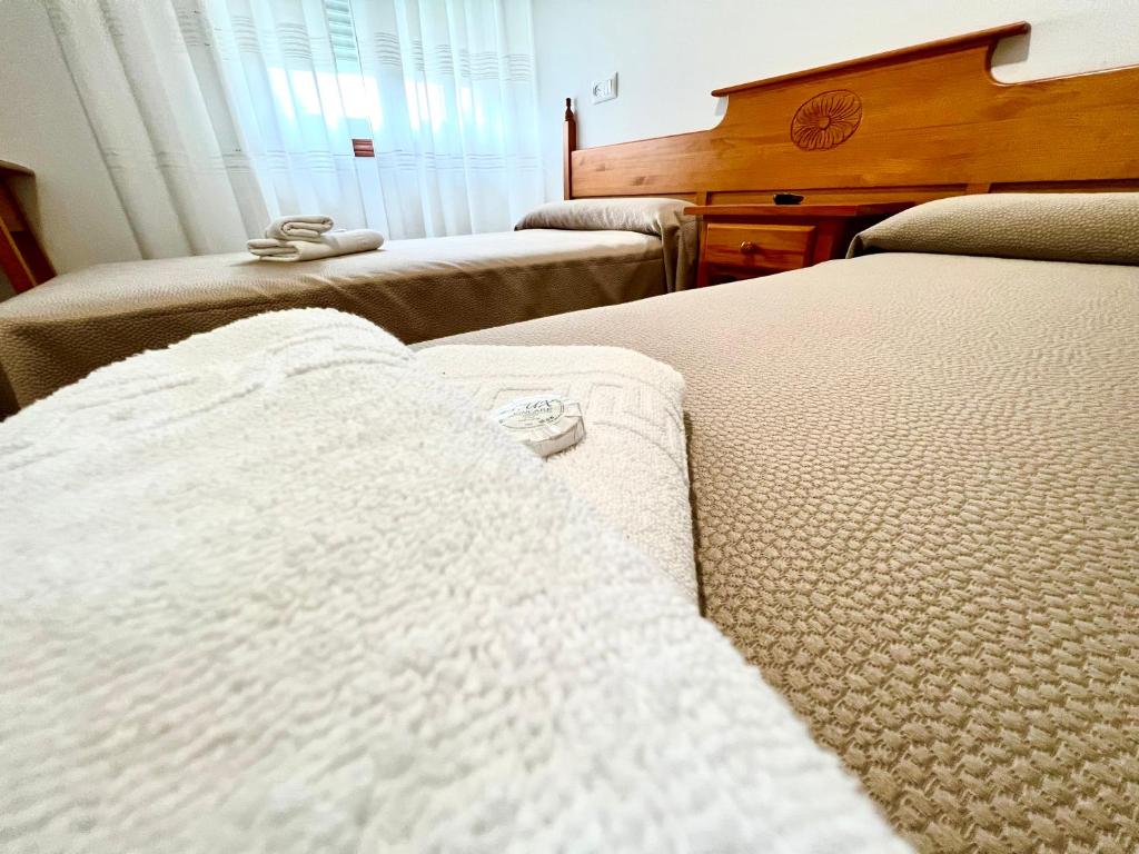 Posteľ alebo postele v izbe v ubytovaní Hostal Eden