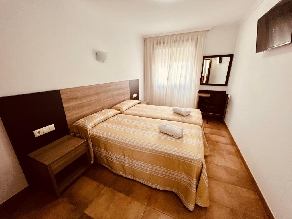 Posteľ alebo postele v izbe v ubytovaní Hostal Eden