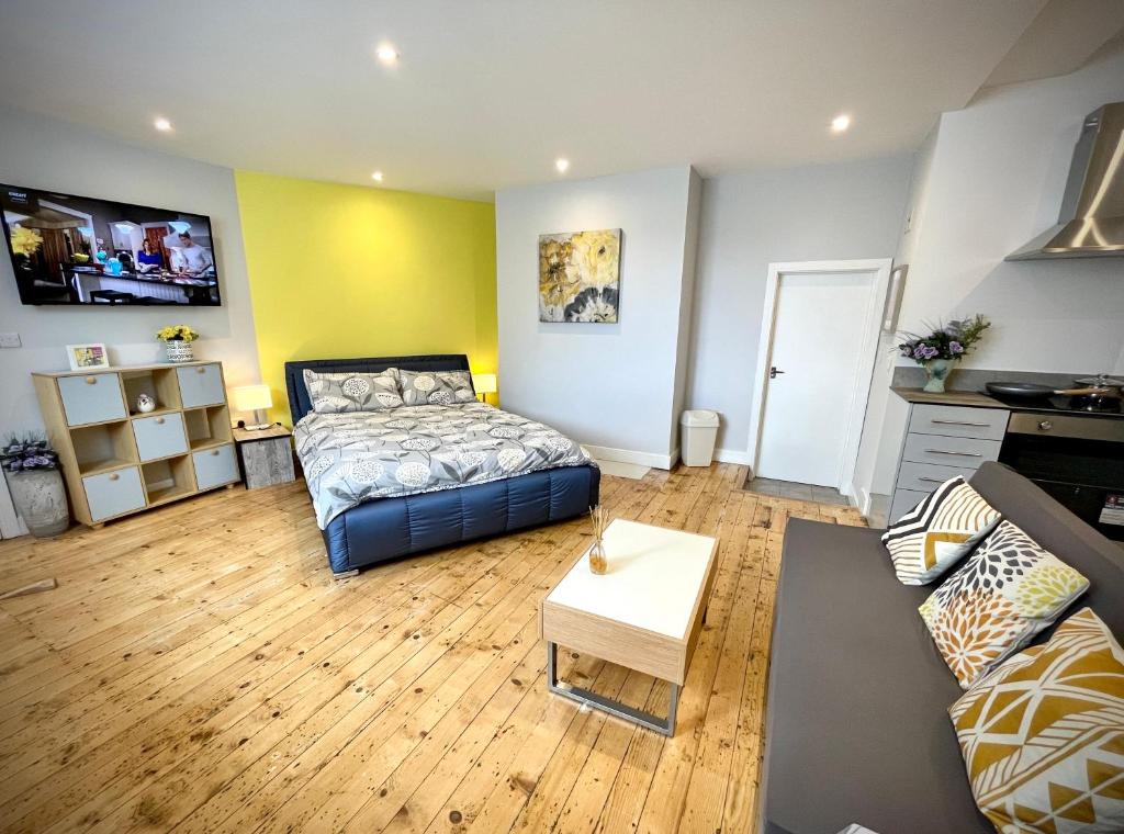 a living room with a bed and a couch at Albion Boutique Guest House in Sunderland