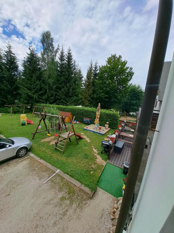 a backyard with a playground with a play equipment at U Bernardýna in Harrachov