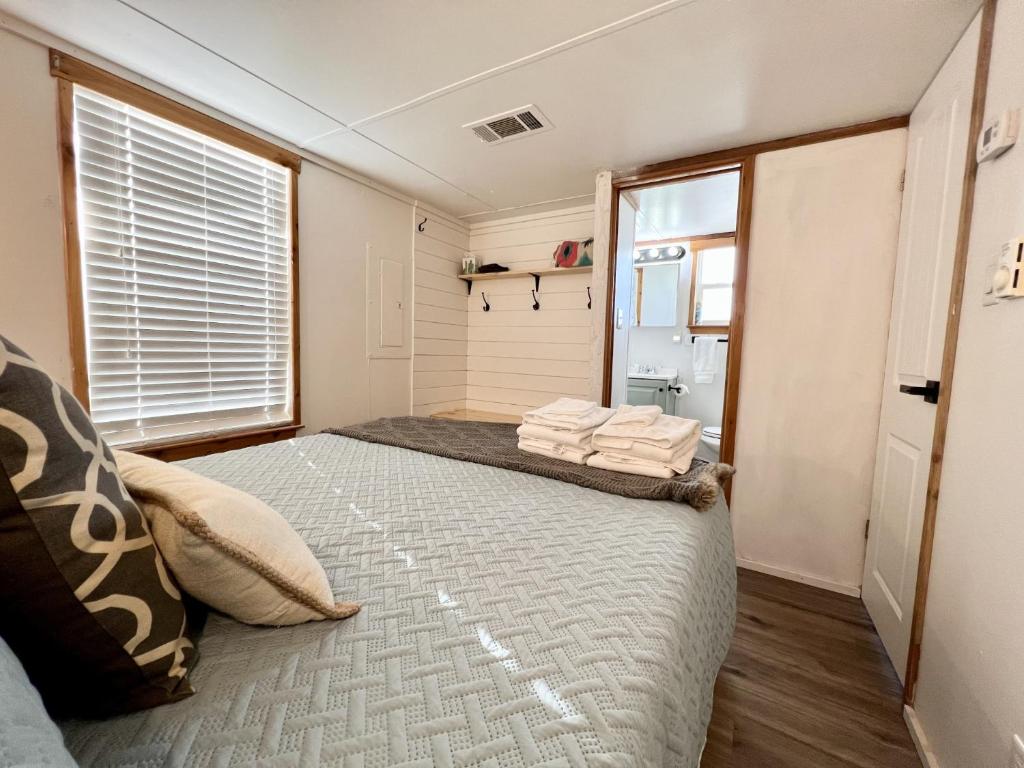 a bedroom with a large bed with a window at The Perch- Texas Tiny Haus with amazing views in Spring Branch