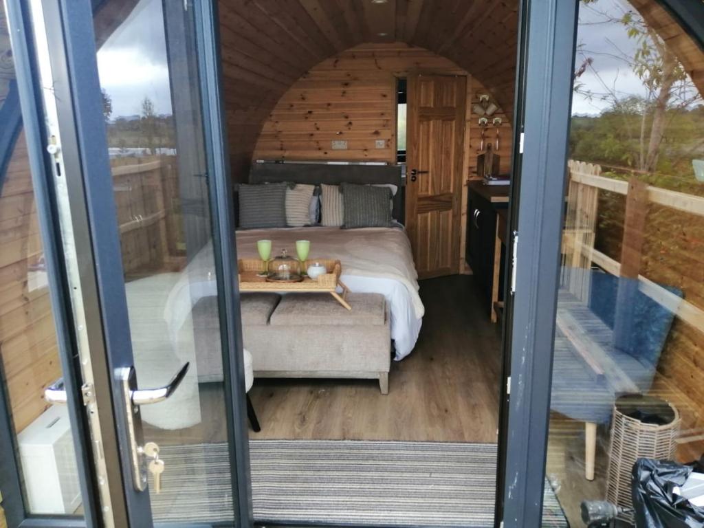 a bedroom with a bed and a table in a room at Luxury Glamping with lake & Mountain View in Culky