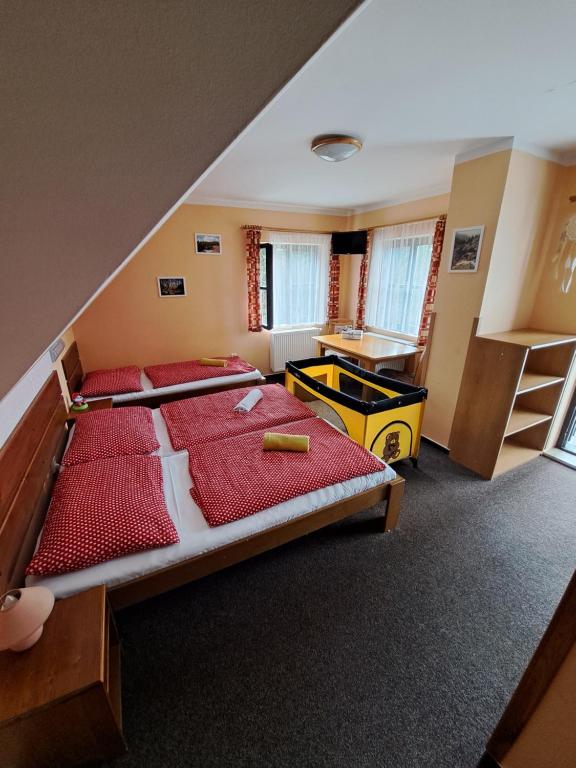 a bedroom with a bed and a desk in it at U Bernardýna in Harrachov