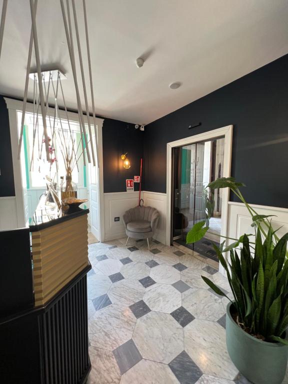 a living room with black walls and a potted plant at Relais Ranieri Piazza Vittoria in Naples