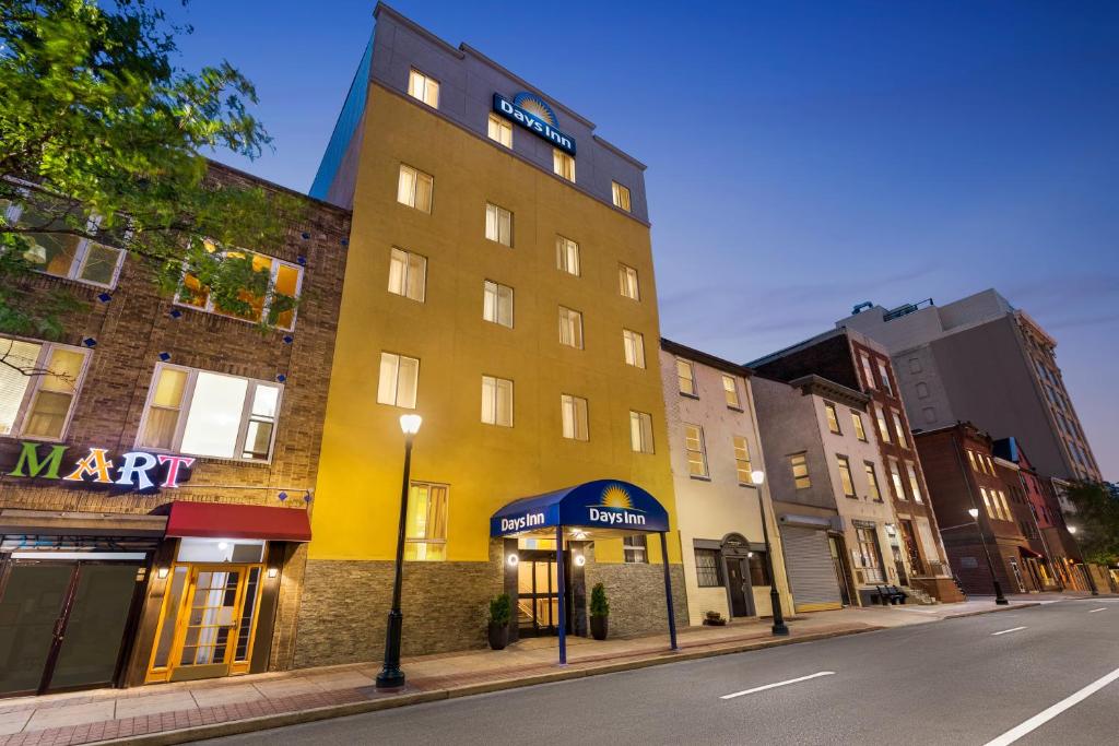 a yellow building on the side of a street at Days Inn by Wyndham Philadelphia Convention Center in Philadelphia