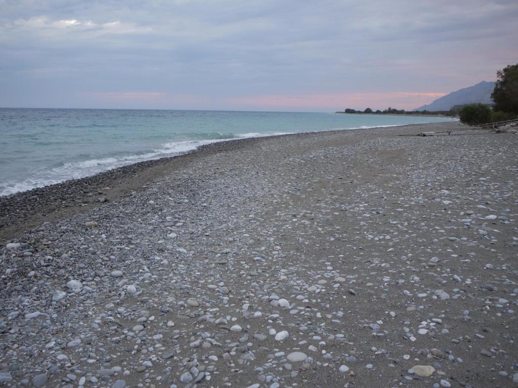 a rocky beach with the ocean in the background at Portela Apartments Kampoula in Keratokampos