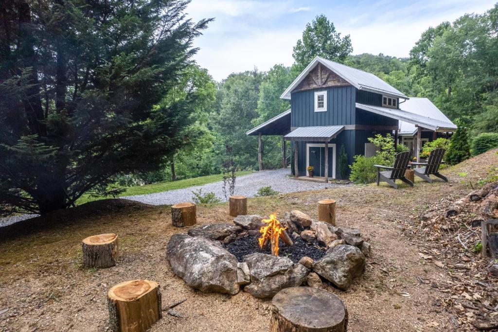 a house with a fire pit in front of it at The Barn in Waynesville