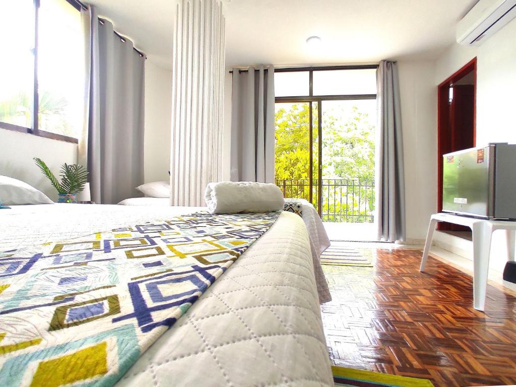 a bedroom with a large bed and a television at Walena Hotel in Ríohacha