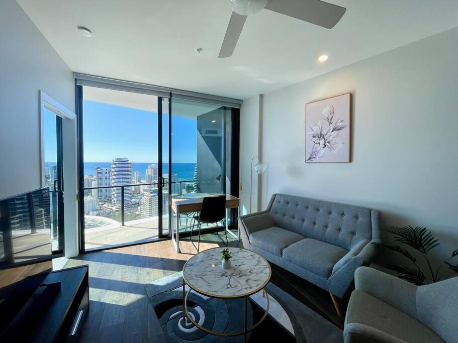 a living room with a couch and a table at Luxury ocean skyline stunner 2beds apt 33F in Gold Coast