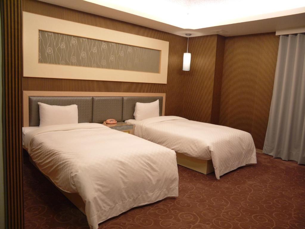 Postel nebo postele na pokoji v ubytování Beidoo Hotel